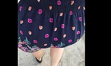 Following a mature woman on the street with skirt and thong