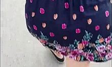 Following a mature woman on the street with skirt and thong