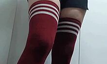 Cheeky change room babe tries on tops topless and nude in thigh high socks without panties