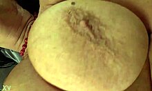 She pampers her saggy tits and self-fists to orgasm