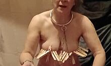 Female slave explores self-bondage with clamps, piss, and belt restraints
