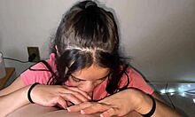 Naughty brunette with hard tits showing on her shirt giving a deep blowjob on a big pink dick