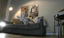 Look at this busty milf stripping her panties on the couch!