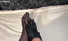 Anna wearing black gloves and fishnet stockings pleasuring herself fingering her ass and pussy