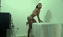 A beautiful brunette massage therapist waits for a client to arrive in her office SHE MOANS while making movements showing her buttocks and breasts