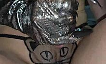 Glove-wearing milf milks cock with hands.