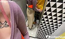 Girlfriend kneels in the changing booth to suck his cock