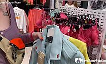 Girlfriend kneels in the changing booth to suck his cock