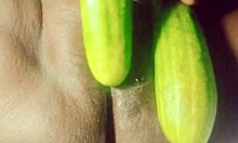 Indian village girl explores body with cucumber in rural setting