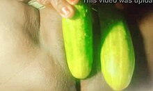 Indian village girl explores body with cucumber in rural setting