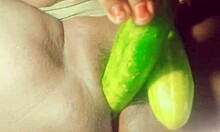 Indian village girl explores body with cucumber in rural setting
