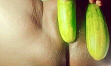 Indian village girl explores body with cucumber in rural setting