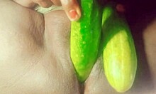 Indian village girl explores body with cucumber in rural setting