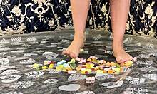 massive brunette milf smothers and crushes gummy bears flat under her giant ass