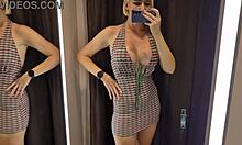 she tries on sexy sheer outfits in the changing room, teasing everyone watching nearby