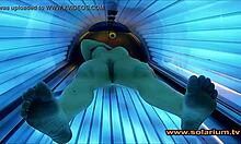 Voyeur cam catches beautiful woman fingering in solarium glow