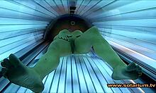 Voyeur cam catches beautiful woman fingering in solarium glow
