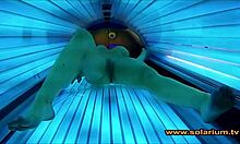 Voyeur cam catches beautiful woman fingering in solarium glow