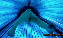 Voyeur cam catches beautiful woman fingering in solarium glow