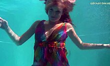 nikita vodorezova strips her redhead tits naked fast right underwater in the pool.