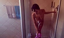 Pierced nipples glisten as tattooed body soaps up seductively in shower