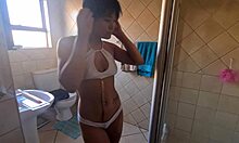 Pierced nipples glisten as tattooed body soaps up seductively in shower