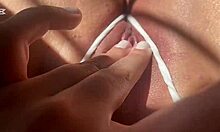 White panties pulled aside as curvy latina fingers wet big clit pussy lips closeup