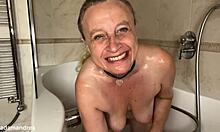 Chubby blonde mommy spreads big pussy lips with dildo in bathroom bath