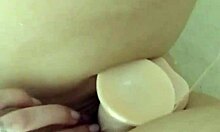 brunette teen spreads wet shaved pussy for shower dildo masturbation closeup