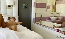 Husband strokes cock in tub watching wife grind dildo on glass wall moaning loud