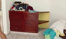 curvy chubby amateur folds clothes while tidying messy room