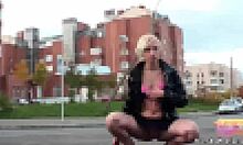 Teen flashes panties under skirt out in field