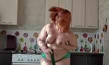 Redhead milf's fat ass shakes while cucumber plunges big pussy close-up