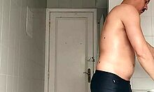 Sexy Guy Shaves Pubes Smooth in Black Beach Shorts Bathroom