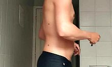 Sexy Guy Shaves Pubes Smooth in Black Beach Shorts Bathroom