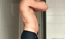 Sexy Guy Shaves Pubes Smooth in Black Beach Shorts Bathroom