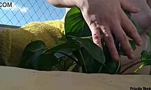 naked tattooed babe waters plants on public balcony