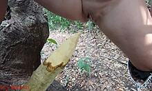 damn this perverted slut squirts piss all over that wooden stake deep in the forest
