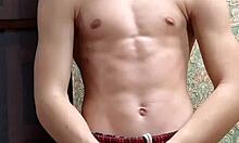 Skinny flexible boy stretches and flexes right after studying.