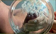 gilf with tan lines jerks huge cock then takes slowmo cumshot in water with friend watching closeup