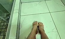 milf delivers slippery footjob on cock in steamy morning shower