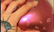 Tattooed Babe Inflates Balloons While Teasing in Sudsy Bath