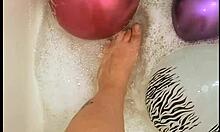 Tattooed Babe Inflates Balloons While Teasing in Sudsy Bath