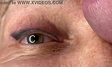 Mature lady moans as huge load blasts across her eyes and face