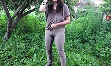 wet milf soaks jeans with hot piss in public garden outdoors