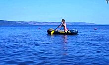 mature couple relaxes on boat in volga river water wearing bikinis