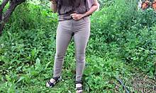 wet milf soaks jeans with hot piss in public garden outdoors