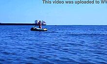 mature couple relaxes on boat in volga river water wearing bikinis