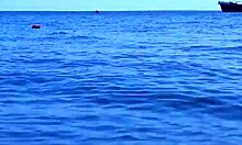 mature couple relaxes on boat in volga river water wearing bikinis