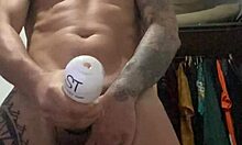 Tattooed girl stands for slow-motion cumshot exposing pierced nipples